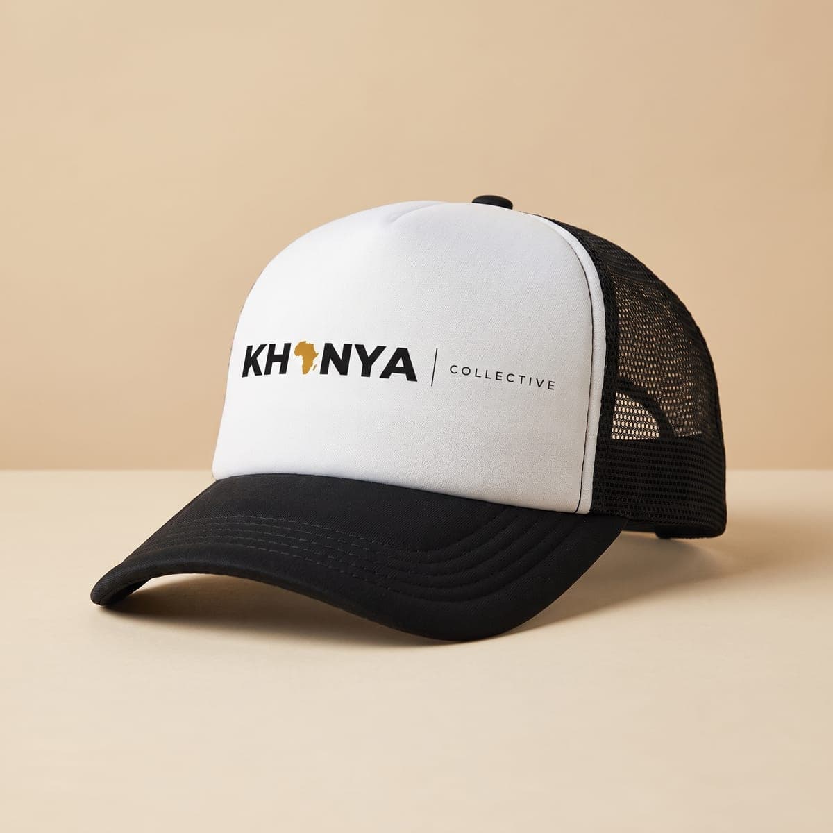 White and black trucker cap with the Khanya Collective logo printed on the front panel