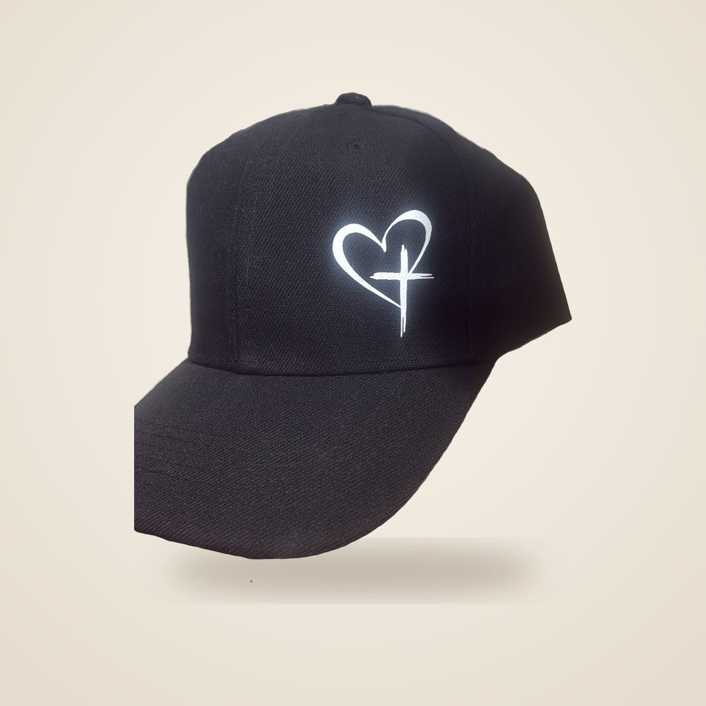 Black cap with a white heart-and-cross print on the front