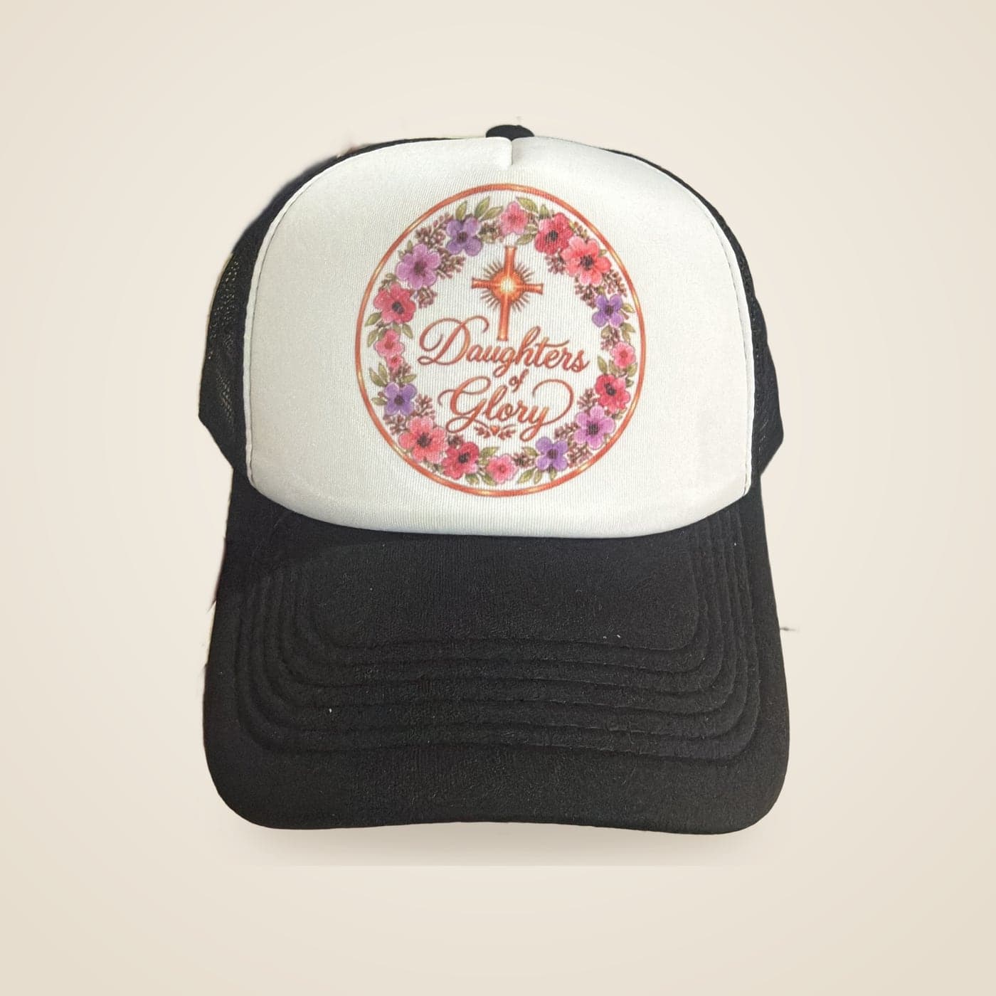 Custom trucker cap with a full-colour floral 'Daughters of Glory' design, made by The Khanya Collective